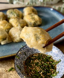 Food sticks holding rice dumpling over soucer with soy souce 